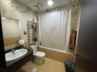 a bathroom with a white toilet and a sink at Luxury hub in Dubai