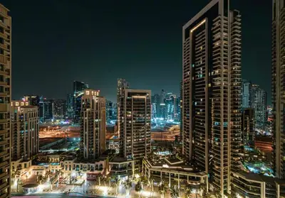 a night view of a city with tall buildings at Act One Act Two - Close to Dubai Mall & Burj Khalifa - Downtown Dubai - Luxury Apartments by Canvas Holiday Homes in Dubai