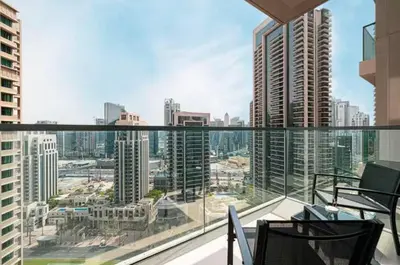 a balcony with a view of a city with tall buildings at Act One Act Two - Close to Dubai Mall & Burj Khalifa - Downtown Dubai - Luxury Apartments by Canvas Holiday Homes in Dubai