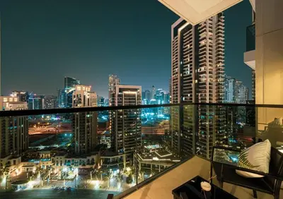 a view of a city at night from a balcony at Act One Act Two - Close to Dubai Mall & Burj Khalifa - Downtown Dubai - Luxury Apartments by Canvas Holiday Homes in Dubai