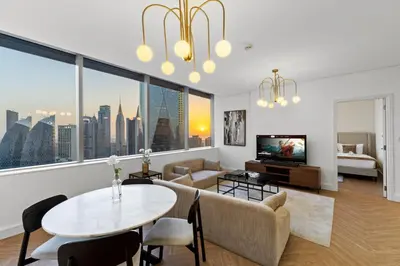 a living room with a table and a couch at Luxury Apt DIFC, XL Layout, Pool, Gym, Skyline View in Dubai