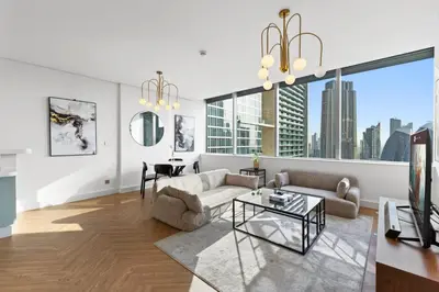 a living room with a couch and a table at Luxury Apt DIFC, XL Layout, Pool, Gym, Skyline View in Dubai