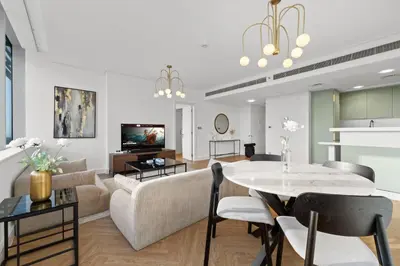 a living room with a couch and a table at Luxury Apt DIFC, XL Layout, Pool, Gym, Skyline View in Dubai