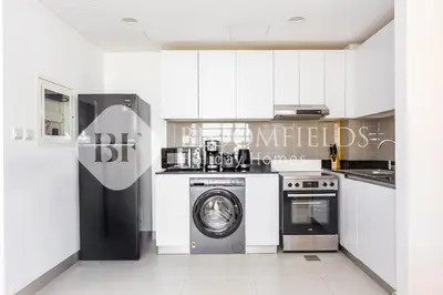 a kitchen with a washing machine and a washer at Bloomfields 1br Elegant Escape The Pulse in Dubai