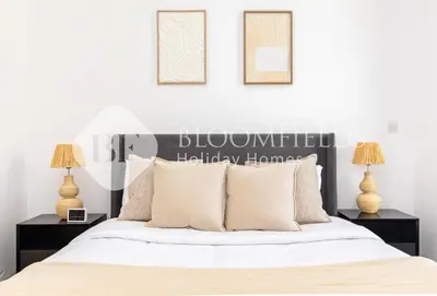 a bedroom with a large bed with two night stands at Bloomfields 1br Elegant Escape The Pulse in Dubai
