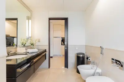 a bathroom with two sinks and a toilet at The Prestige in Dubai