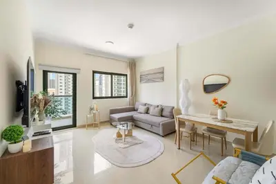 a living room with a couch and a table at Luxury Marina Living with Pool Gym & near the beach in Dubai