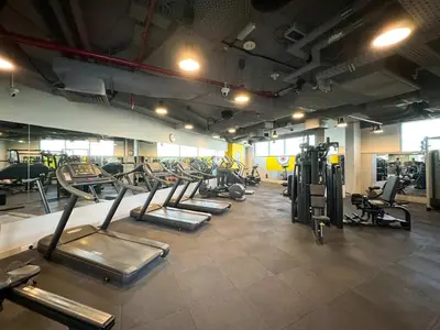 a gym with a row of treadms and machines at King Bed & Modern Comfort Studio in DIFC Downtown in Dubai