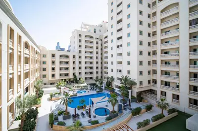 an aerial view of a large building with a swimming pool at Oasis by Tarrab in Dubai