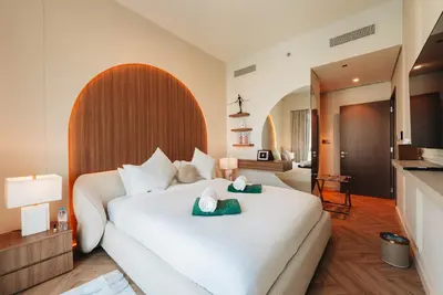 a bedroom with a large white bed with two towels on it at Stylish 2-Bedroom Luxury Stay in Downtown Dubai with Burj Khalifa & Fountain Views in Dubai