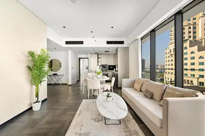 a living room with a white couch and a table at Chic 2BR Close to Burj Khalifa, Dubai Mall & Creek in Dubai