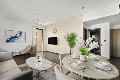 a living room with a table and chairs at Chic 2BR Close to Burj Khalifa, Dubai Mall & Creek in Dubai