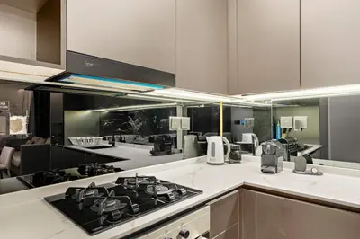 a kitchen with a stove top oven in a kitchen at Chic 2BR Close to Burj Khalifa, Dubai Mall & Creek in Dubai