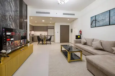 a living room with a couch and a table at Grande 2BR Apartment with Burj Khalifa & Fountain Views in Dubai
