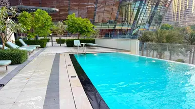 a swimming pool on top of a building at Grande 2BR Apartment with Burj Khalifa & Fountain Views in Dubai