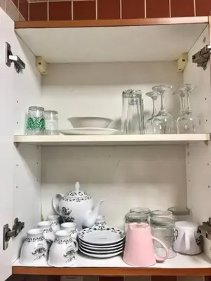 a shelf with a lot of dishes and jars at Luxury Apartment- 5 min Walking Distance Beach and 3 minutes walking distance Metro in Dubai