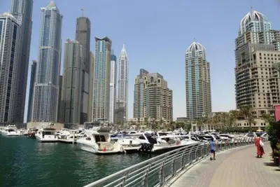 a group of boats docked in a harbor with a city at Luxury Apartment- 5 min Walking Distance Beach and 3 minutes walking distance Metro in Dubai