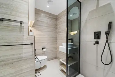 a bathroom with a shower and a toilet and a sink at 3BR plus Maid Rimal 4 Direct Beach Access in Dubai