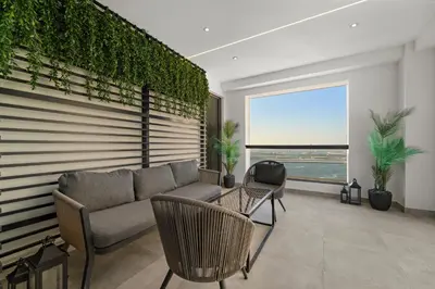 a living room with a couch and a large window at 3BR plus Maid Rimal 4 Direct Beach Access in Dubai