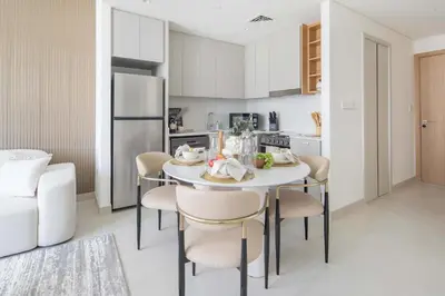 a kitchen and dining room with a table and chairs at Frank Porter - Creek Crescent Tower 1 in Dubai