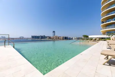 a swimming pool with a view of the city at Maison Privee - Coastal Living with Uninterrupted Sea & Palm Views in Dubai