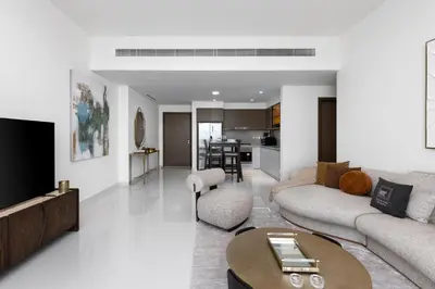 a living room with a couch and a table at Maison Privee - Coastal Living with Uninterrupted Sea & Palm Views in Dubai