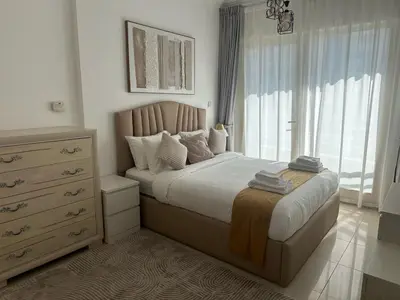 a bedroom with a bed with a dresser and a window at Dubai Marina-2Bedroom-3 balcony with view-direct acces to Marina Promenade in Dubai
