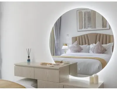 a bedroom with a large bed with a round mirror at Dubai Marina-2Bedroom-3 balcony with view-direct acces to Marina Promenade in Dubai