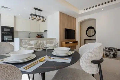 a dining room with a table and chairs at Ranches 1 Upgraded Three Bedroom Villa in Dubai