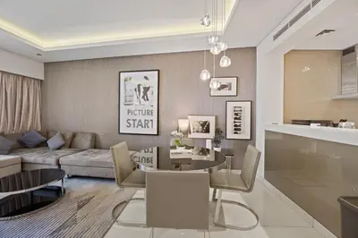a living room with a couch and a table at Elite Escapes - Glamorous 1BR DAMAC Paramount B in Dubai