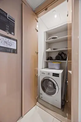 a washer and dryer in a small room at Elite Escapes - Glamorous 1BR DAMAC Paramount B in Dubai