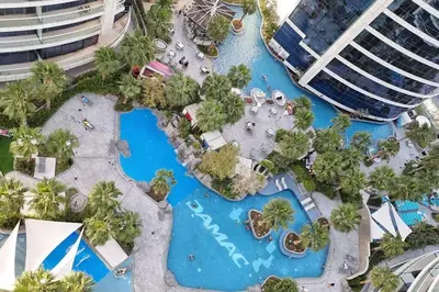an aerial view of a pool at a resort at Elite Escapes - Glamorous 1BR DAMAC Paramount B in Dubai
