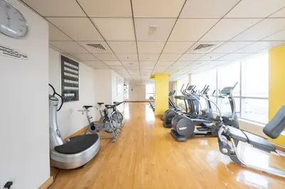 a gym with treadmills and bikes in a room at Charming Stay by Dubai Marina in Dubai