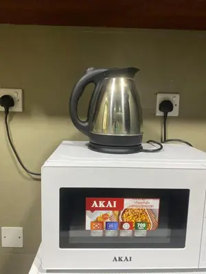 a tea kettle on top of a microwave at Dorm&GO in Dubai