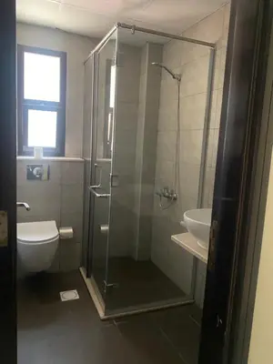 a bathroom with a shower and a toilet and a sink at Dorm&GO in Dubai