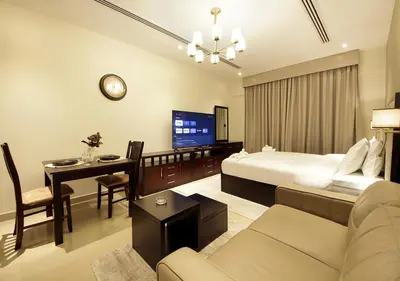a hotel room with a bed and a desk and a couch at Breathtaking Views from a H-Floor Studio in Dubai in Dubai
