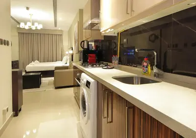 a kitchen with a sink and a dishwasher at Breathtaking Views from a H-Floor Studio in Dubai in Dubai