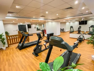 a gym with treadmills and ellipticals in a room at Breathtaking Views from a H-Floor Studio in Dubai in Dubai