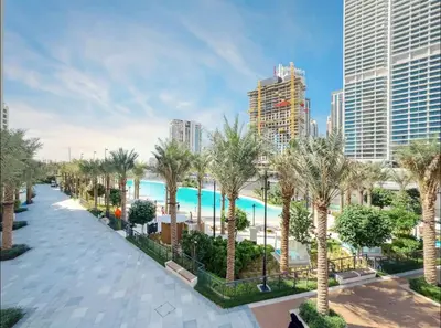 an aerial view of a resort with a pool and palm trees at Modern 2BR Apartment - Vida Residences Creek Beach - Creek Beach Access in Dubai