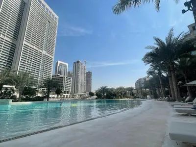 a pool in the middle of a city with tall buildings at Modern 2BR Apartment - Vida Residences Creek Beach - Creek Beach Access in Dubai