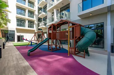 a playground in a building with a slide at Chic Studio in Prime JVC Spot - Holiday Boulevard in Dubai