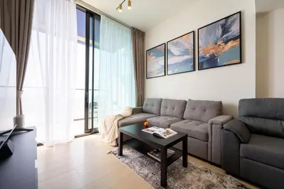 a living room with a couch and a table at Cozy NEW brand 1BR at JVC Binghatti Corner in Dubai