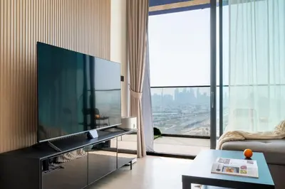 a living room with a large flat screen tv at Cozy NEW brand 1BR at JVC Binghatti Corner in Dubai