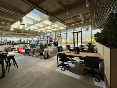 an office with tables and chairs and a lot of windows at THE UPSIDE Downtown Dubai in Dubai