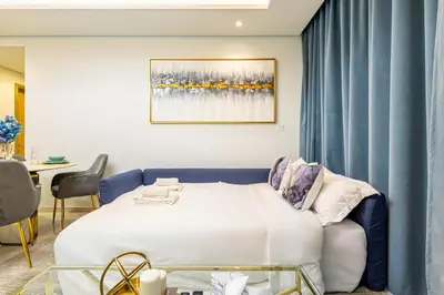 a hotel room with a bed and a table at Infinity Rooftop Pool with Full Burj Khalifa View in Dubai