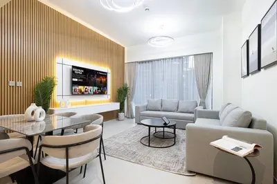 a living room with a couch and a table at Grande Signature by Emaar! Amazing Pool, Gym and Location! in Dubai