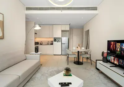 a living room with a couch and a table at Cozy 1BR The Address JBR in Dubai