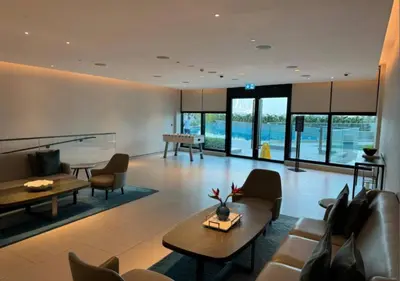 a living room with a couch and tables and chairs at Cozy 1BR The Address JBR in Dubai