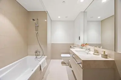 a bathroom with a tub and a toilet and a sink at Act tower-1BR near burj khalifa in Dubai