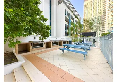 three blue benches sitting on a sidewalk in a city at Luxe Vista - Top Location Dubai Marina 1BR - Metro and Beach Access in Dubai